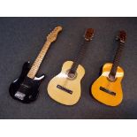 Three beginner guitars comprising an Elica six string solid body model and two acoustic guitars,