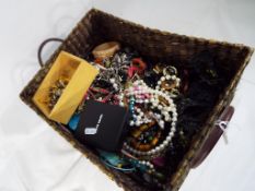 A large basket containing a very large quantity of unsorted costume jewellery - This lot MUST be
