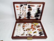 Angling - a carry case containing 107 fishing flies,
