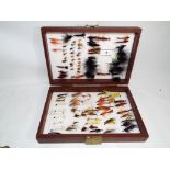 Angling - a carry case containing 107 fishing flies,