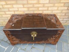 A 20th century African carved wood linen chest, 48 cm x 88 cm x 43 cm,