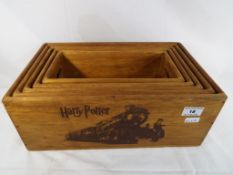 Five graduated wooden trays depicting Harry Potter Magic,