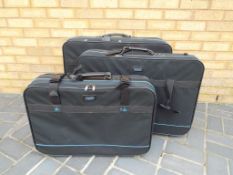 A set of three canvas nesting suitcases - This lot MUST be paid for and collected,