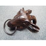 A large cast iron bathroom towel holder in the form of a goat's head,