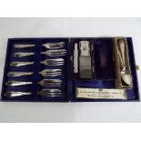 A small mixed lot comprising a cased set of six plated cake forks,