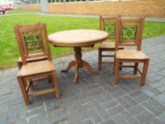 A good quality heavy pine circular extending kitchen table with four matching chairs 77 cm x 105 cm