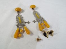 A pair of amber style drop earrings with