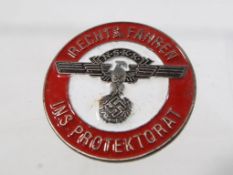 A pin badge displaying a German emblem -