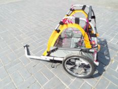 A child's bicycle carrier trailer with c