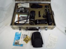 A Praktica Super TL1000 camera in protective hard case with additional lenses,