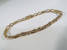 A yellow metal stone set bracelet stamped 375 indicating 9 carat gold, approx 6.
