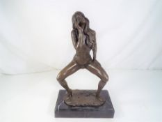 A hot cast bronze depicting a female on a marble plinth, approximate height 31 cm (h).