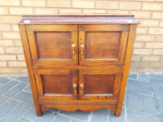 A mahogany four door cabinet with hinged lid approx 66cm (h) x 60cm (w) x 36cm (d)