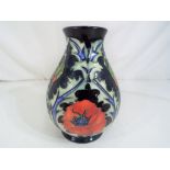 Moorcroft Pottery - A small Moorcroft pottery vase decorated with poppies on a blue ground,