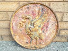 A large cast iron wall plaque featuring a depiction of a Liver Bird,