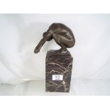 A hot cast bronze depicting a Diver mounted on a marble cuboid base, after Milo,