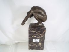 A hot cast bronze depicting a Diver mounted on a marble cuboid base, after Milo,
