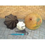 A collection of parasols to include wood and paper construction,