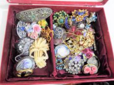 A jewellery box containing in excess of 30 predominantly vintage lady's brooches,