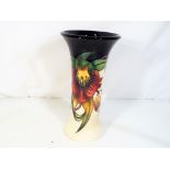 Moorcroft - a Moorcroft decorated in the Anna Lily pattern, approximate height 21 cm (h).