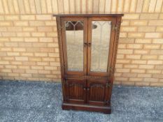 A Nathan oak linen fronted two door cabinet approx 109cm x 58cm x 46cm