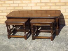 Ercol - a dark wood rectangular occasional table with two smaller matched tables,