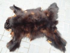 Taxidermy - a bear pelt / skin rug approx 135cm (l) Est £80 - £120