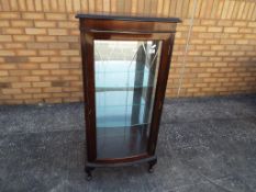 A good quality display cabinet with two internal glass shelves, mirrored back,
