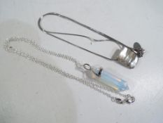 Two silver necklaces and pendants.