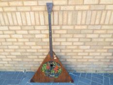 A large Balalaika instrument with hand painted decoration depicting fruit approx 142cm (h)