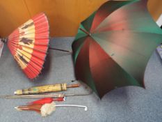 A collection of parasols to include Oriental paper and wood,