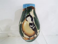Moorcroft - a Moorcroft vase decorated in the Coal Tits pattern, approximate height 14 cm (h).
