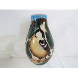 Moorcroft - a Moorcroft vase decorated in the Coal Tits pattern, approximate height 14 cm (h).