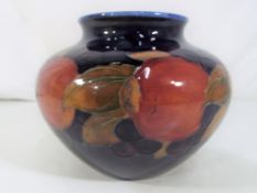 Moorcroft Pottery - A large bulbous squat vase decorated in pomegranate pattern,