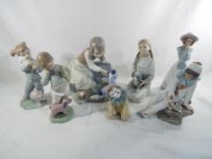 Nao - seven Nao figurines predominantly depicting children the largest approx 20cm (h) (7) Est £20