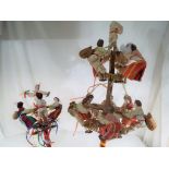 Two wooden doll's dance displays featuring ten dolls with bells and castanets,