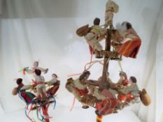 Two wooden doll's dance displays featuring ten dolls with bells and castanets,