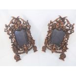 A pair of Victorian cast metal picture / photograph frames featuring ornate cherubs with flowers,