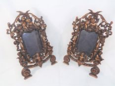A pair of Victorian cast metal picture / photograph frames featuring ornate cherubs with flowers,