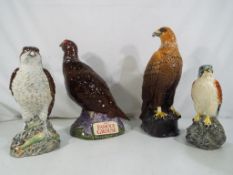 Beswick - four ceramic advertising decanters / bottles (empty) comprising an Osprey and Kestrel and