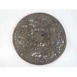 A metal plaque with pierced decoration depicting classical figures,