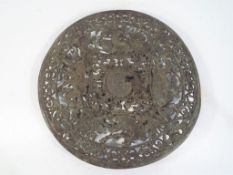 A metal plaque with pierced decoration depicting classical figures,