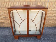 An Art Deco sunburst glass fronted display cabinet with lock and key,