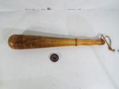 A turned wooden truncheon approx 43.