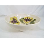 Moorcroft Pottery - A large Moorcroft pottery footed bowl decorated with hibiscus on a cream ground,