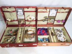 Two Asian style jewellery boxes containing a quantity of costume jewellery to include rings,