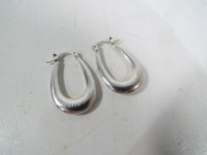 A pair of silver sleeper earrings inscribed Tiffany & Co.