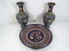 A pair of Chinese cloisonne vases depicting five clawed dragons chasing a flaming pearl,