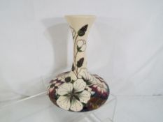 Moorcroft - a Moorcroft vase decorated in the Bramble Revisited pattern, approximate height 16 cm.
