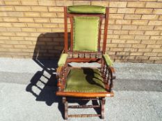 A good quality American rocking chair with green upholstery